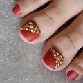 Red toenails with gold rhinestones on a neutral background, Obroi