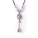 Obroi Necklace with pastel beads and a decorative pendant on a white background
