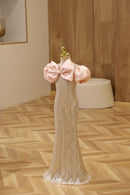 Mannequin wearing a sparkly dress with pink sleeves on a wooden floor, Obroi