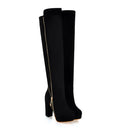 Black knee-high boots with a gold zipper on a white background, Obroi