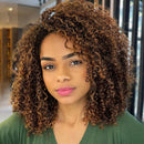 Woman with curly hair wearing a green top indoors, Obroi