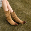 Tan suede boots worn on a grassy surface, Obroi