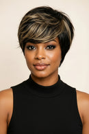 Short layered wig shown on a model in a close-up portrait, plus two mannequin views showing the front and back. The wig has a dark black base with warm blonde highlights, Obroi
