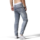 Person wearing light blue jeans with 'Obroi' branding on a white background