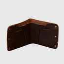 Brown leather wallet with gold rivets on a light gray background, Obroi