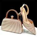 Rose gold clutch bag and high-heeled shoe with rhinestone detailing on a white background, Obroi