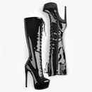 Black patent leather knee-high boots with high platforms on a white background, Obroi