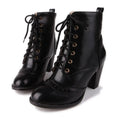 Pair of black lace-up boots on a white background, Obroi