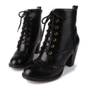 Pair of black lace-up boots on a white background, Obroi