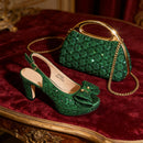 Green glittery shoes and handbag on a red velvet surface, Obroi