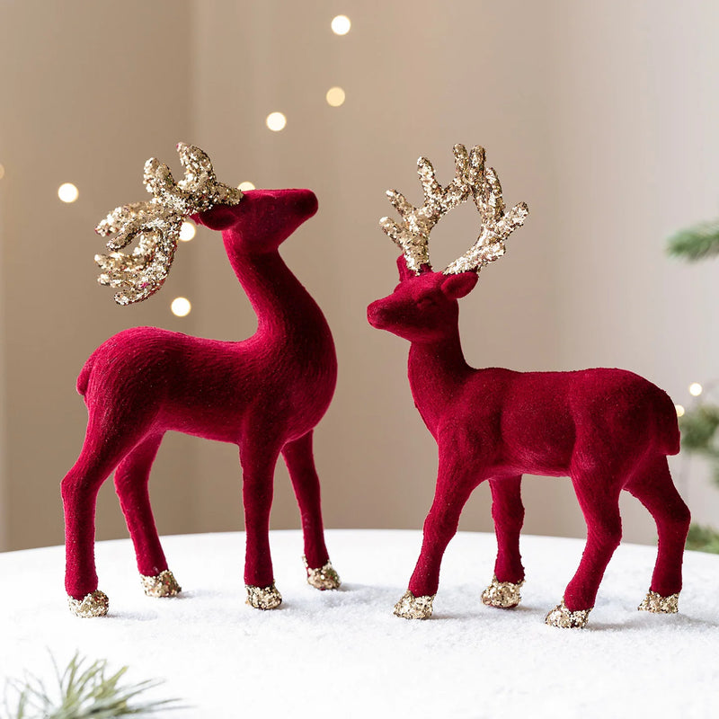 Two red deer figurines with gold antlers on a neutral , Obroi