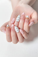 Hand with pink and white nail art on a light background, Obroi