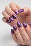 Close-up of hands with purple and pink nail design on a blurred background, Obroi