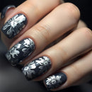 Nails with black and white floral design on a dark background, Obroi