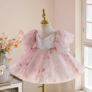Pink and white dress on a mannequin with a blurred indoor background, Obroi