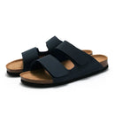 Pair of black sandals with cork soles on a white background, Obroi