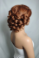 Mannequin head with a styled brown hairdo on a plain background, Obroi