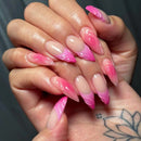 Close-up of hands with pink and white gradient nail designs, Obroi.