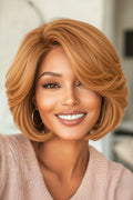 Woman with styled blonde hair wearing a pink sweater indoors, Obroi
