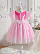 Pink dress on a mannequin against a decorative white wall, Obroi