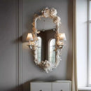 Decorative floral mirror on a wall with soft lighting, Obroi