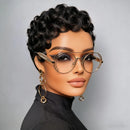 Woman wearing gold-framed glasses and gold earrings against a gray background, Obroi