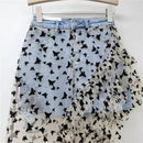 Denim skirt with black butterfly pattern on a white background, Obroi