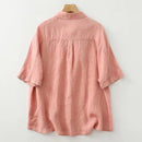 Pink shirt on a wooden hanger against a white background, Obroi