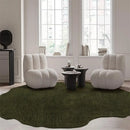 Modern living room with two white armchairs, a green rug, and a window in the background, Obroi