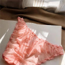 Pink lace lingerie on a white surface with a blurred background, Obroi