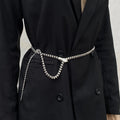 Black coat with a silver belt featuring a snake design on a neutral background, Obroi