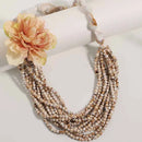 Multistrand beaded necklace with a peach flower on a white background, Obroi