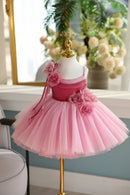 Pink dress with floral details on a mannequin against a blurred indoor background, Obroi