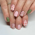 Close-up of hands with colorful nail designs on a white background, Obroi