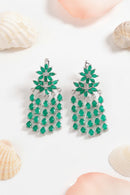Green teardrop earrings on a white surface with seashells, Obroi
