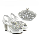 Silver high-heeled shoes with embellishments and a matching clutch on a white background, Obroi