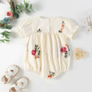 Baby romper with floral patterns on a light background, Obroi