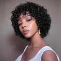 Woman with styled hair wearing a white top against a neutral background, Obroi