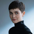 Woman with short dark hair wearing a black turtleneck against a gradient background, Obroi