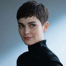 Woman with short dark hair wearing a black turtleneck against a gradient background, Obroi
