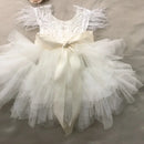 White lace dress with a large bow on a neutral background, Obroi