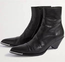 Black leather ankle boots with metallic accents on a white background, Obroi