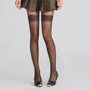 Obroi Person wearing black polka dot tights on a plain background