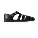 Black sandal on a white background with text indicating size equivalence.