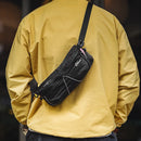 Person wearing a yellow jacket with a black waist bag on a blurred background, Obroi