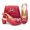 Red high-heeled shoes and matching handbag with decorative bow on a white , Obroi