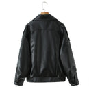 Obroi Black leather jacket on a hanger against a white background