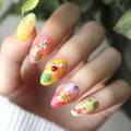 Nail art with colorful designs on a hand, featuring flowers and berries, Obroi