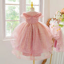 Pink dress on a mannequin in a room with a window and decorative elements, Obroi