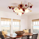 Decorative ceiling light fixture in a room with a wooden table and chairs, Obroi